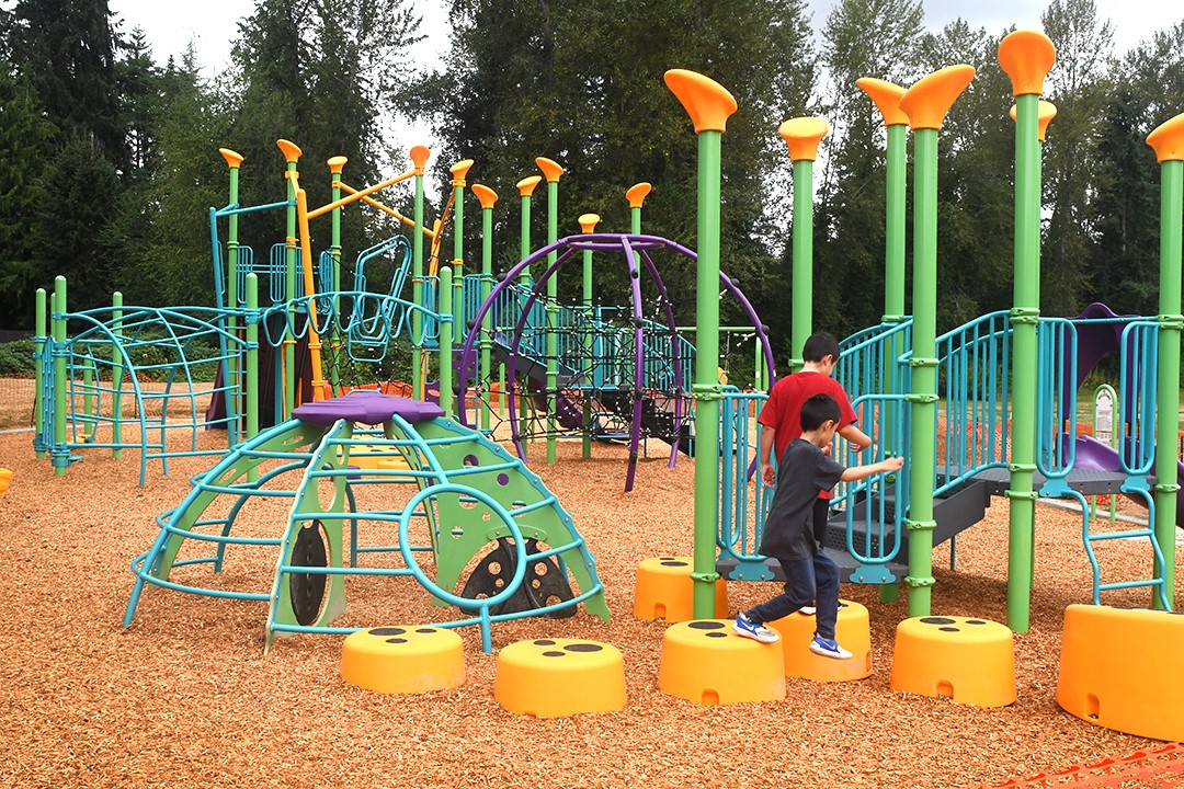 Kids play on colorful new playground equipment at Renton's Cascade Park near Seattle