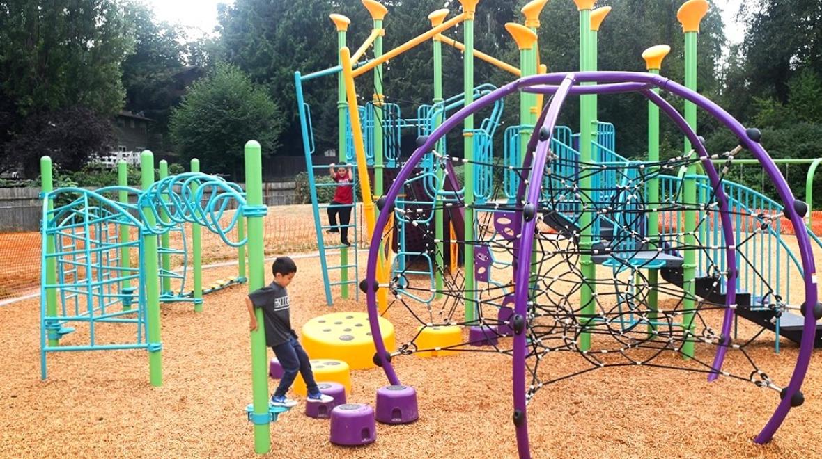Kids play on the new playground equipment at Renton's Cascade Park