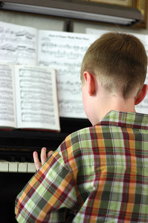 Boy Playing Piano Specialized After School Programs Music