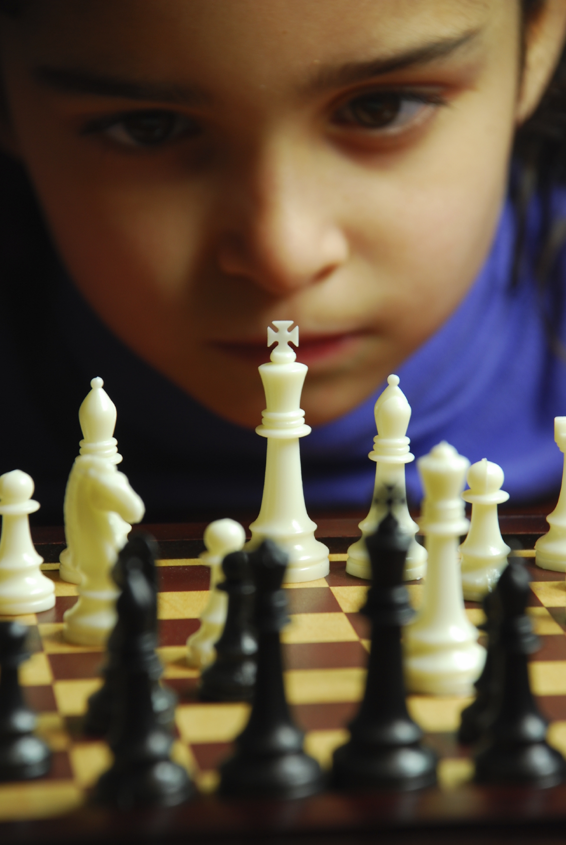 competitiveness in kids when is it too much? Boy playing chess