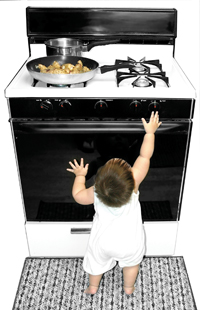 Unattended baby reaching for stove