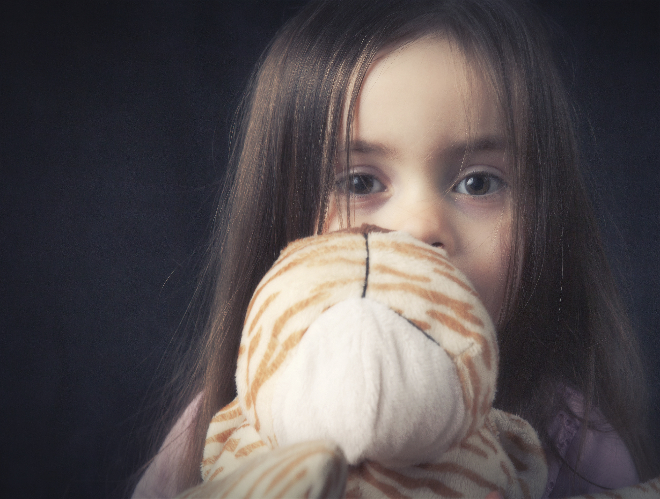 anxious little girl with stuffed animal
