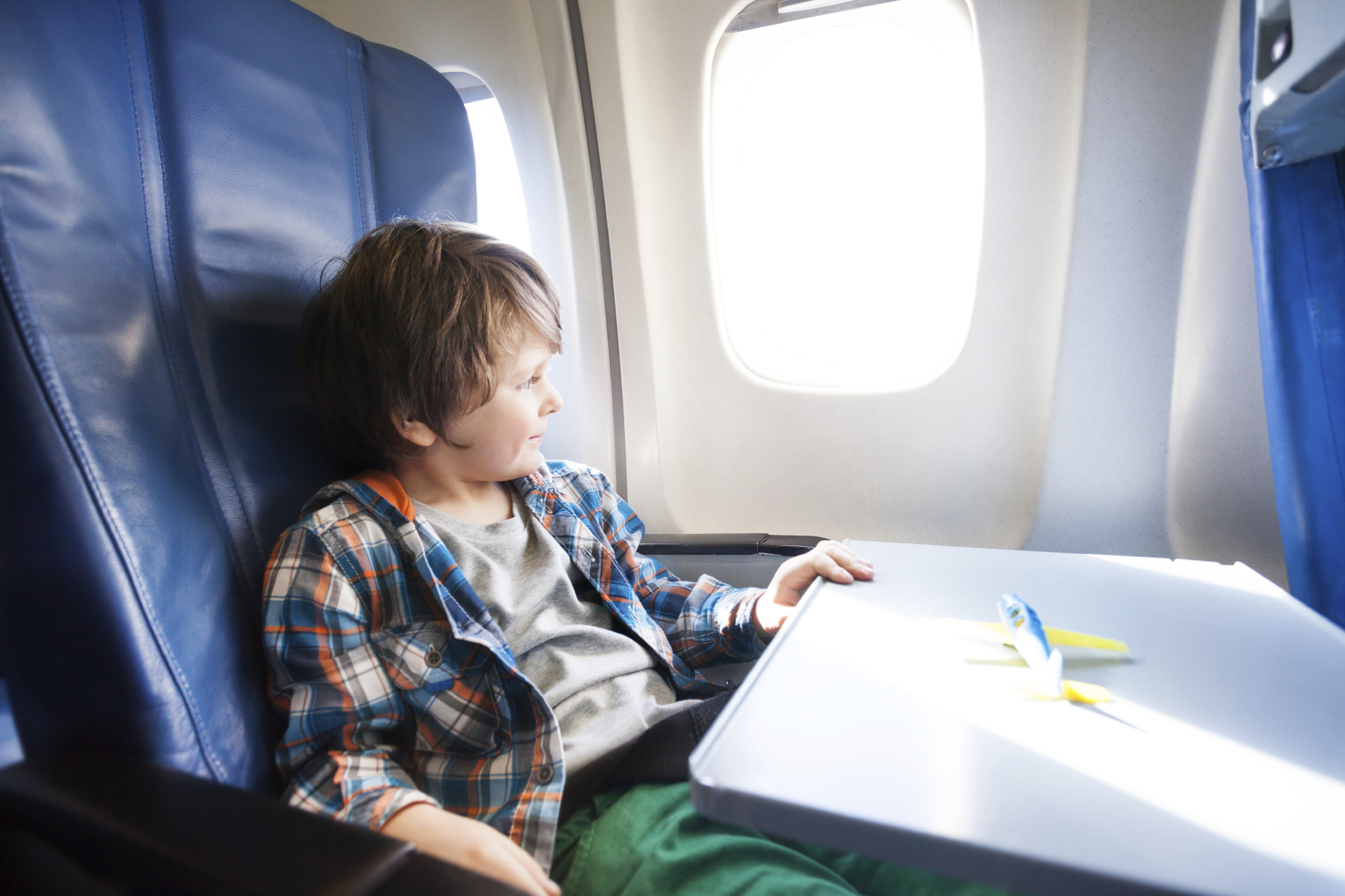 little boy on plane traveling