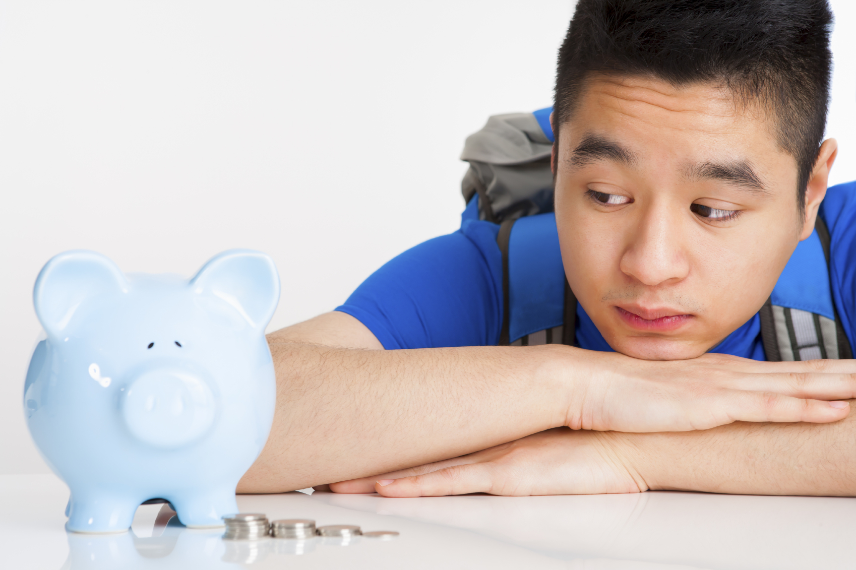 teen boy with college savings piggy bank