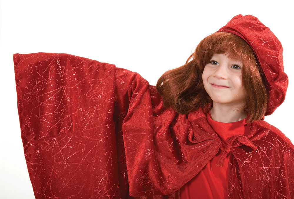 Girl with red hair actor dressed in red cape