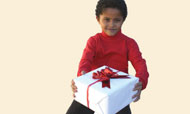Boy holding gift-wrapped box.