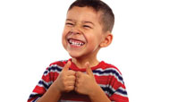 Boy smiling and giving a double thumbs-up.