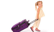 Girl rolling suitcase
