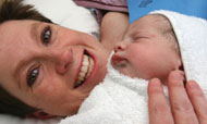 Smiling mother with newborn