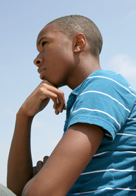 Teen boy contemplating