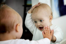 Baby playing with mirror