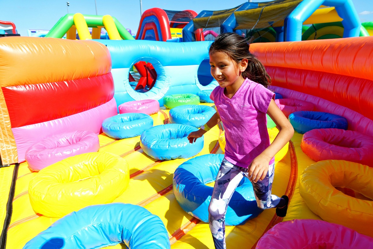 A girl runs in the Bounce The City inflatable maze