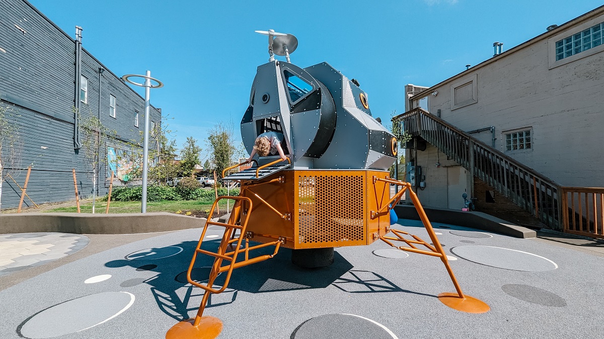 A child peeks out from the lunar lander at Kent's Kherson Park