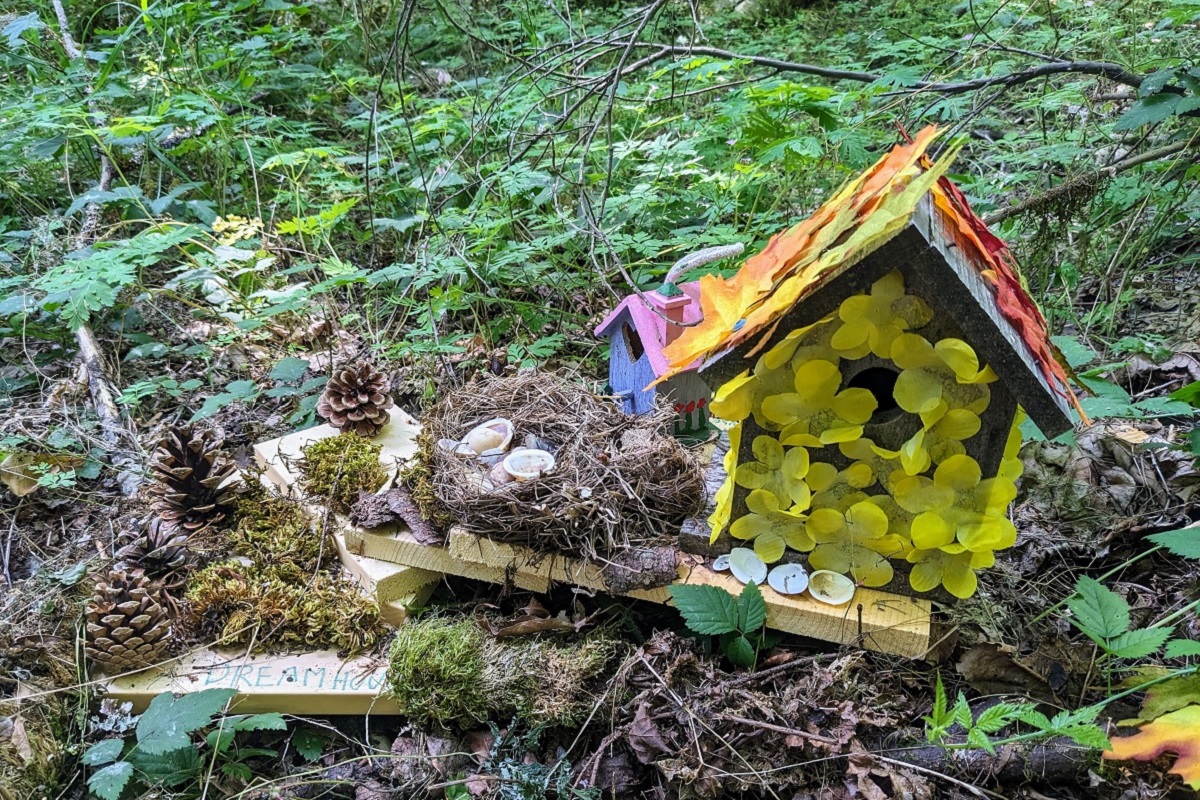 A fairy house along the Fairy House Trail features yellow blossoms and is a favorite among kids visiting