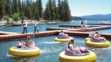 "People driving bumper boats in a lake"