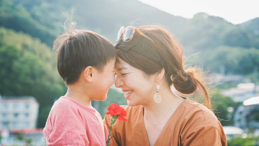 Mom and son share a sweet flower on Mother's Day weekend.