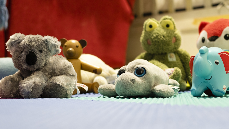 Stuffed animals on the floor serve as a brilliant obstacle course for kids