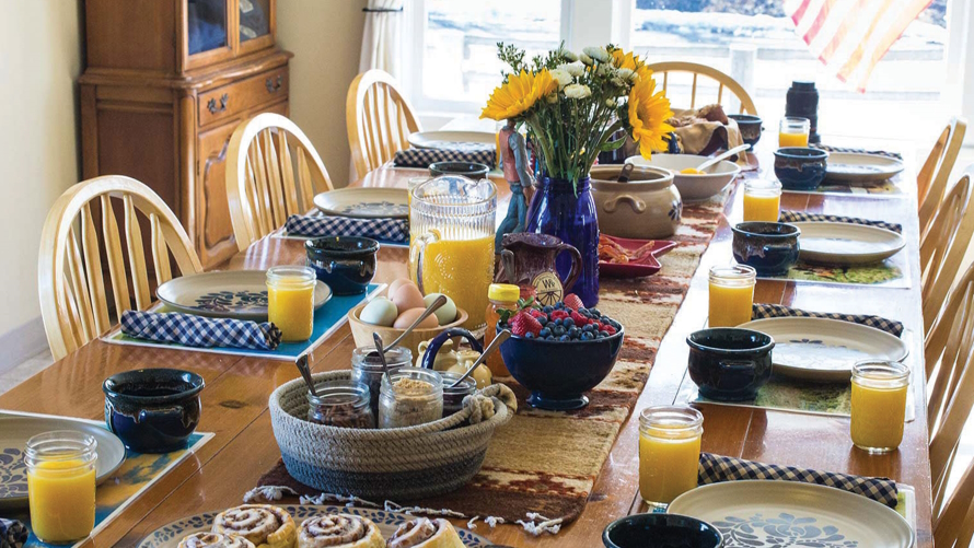 "A table set with a farm breakfast at an overnight farm stay"