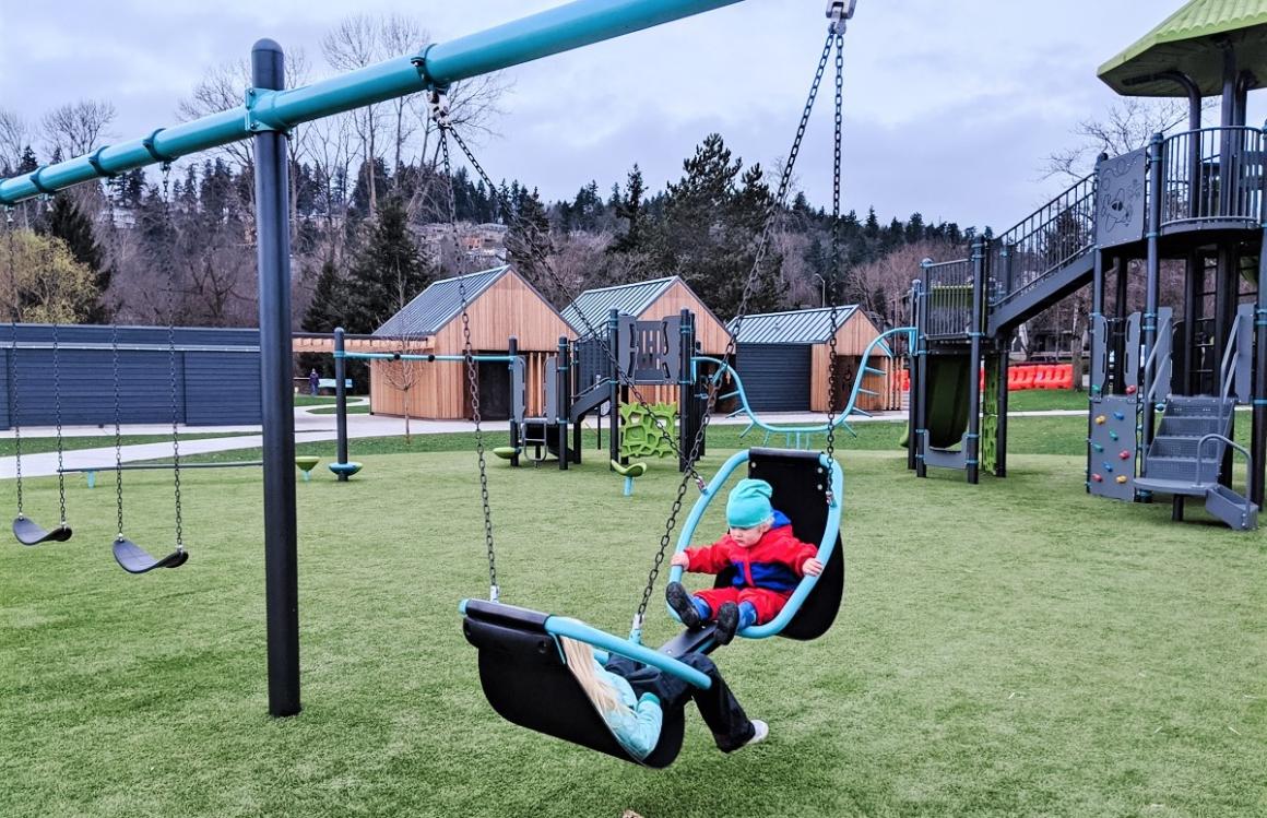 Swings at new all-abilities Juanita Beach Park playground in Kirkland for Seattle and Eastside families