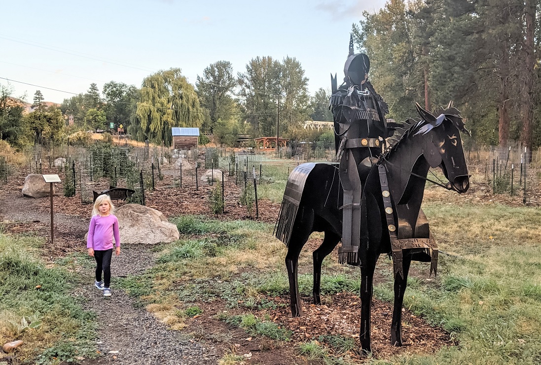 Homestream Park child walking near Native rider on horseback sculpture Winthrop Washington