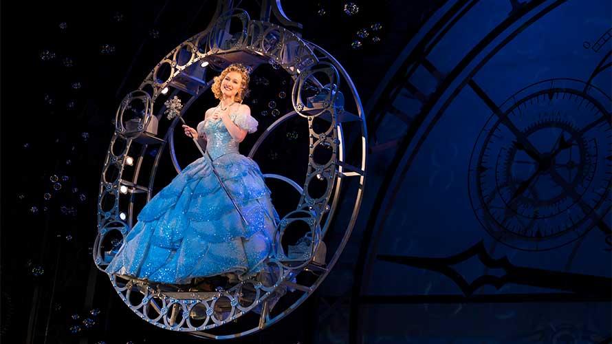 Glinda (Erin Mackey) floating on a bubble wand in Wicked