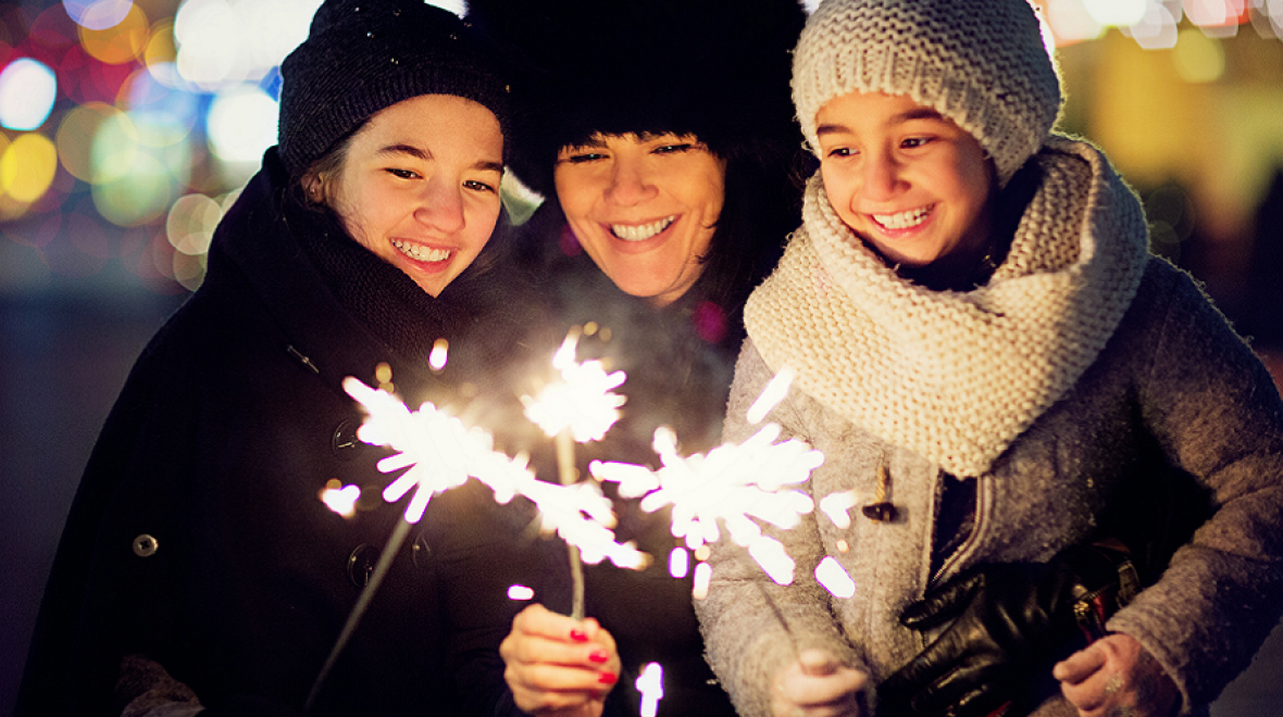 A family celebrates New Year's Eve with sparklers
