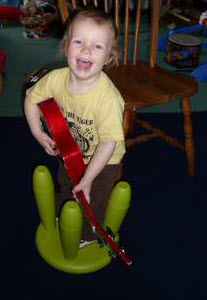 Toddler playing ukulele