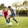 Two boys playiung soccer