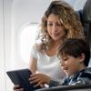mom and son looking at a tablet on an airplane