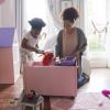 Mom and daughter picking up toys spring cleaning with kids