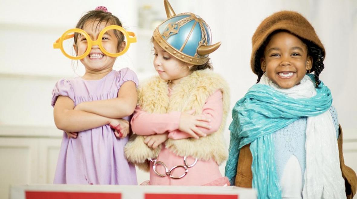 Three young girls playing dress-up
