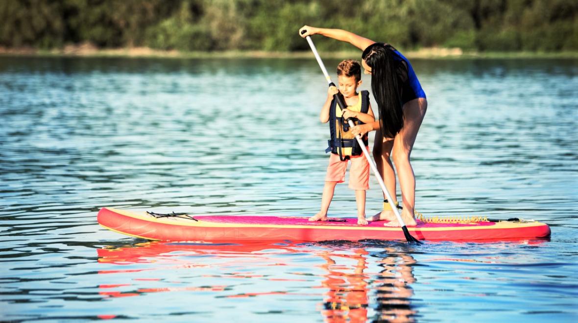 Mom and child stand-up paddleboarding