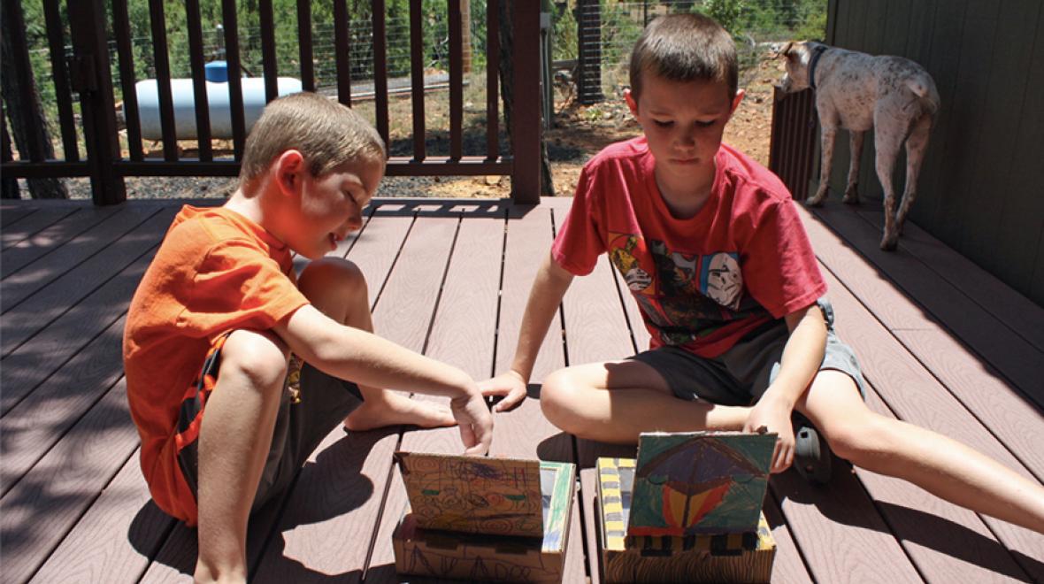 Two children making solar oven s'mores