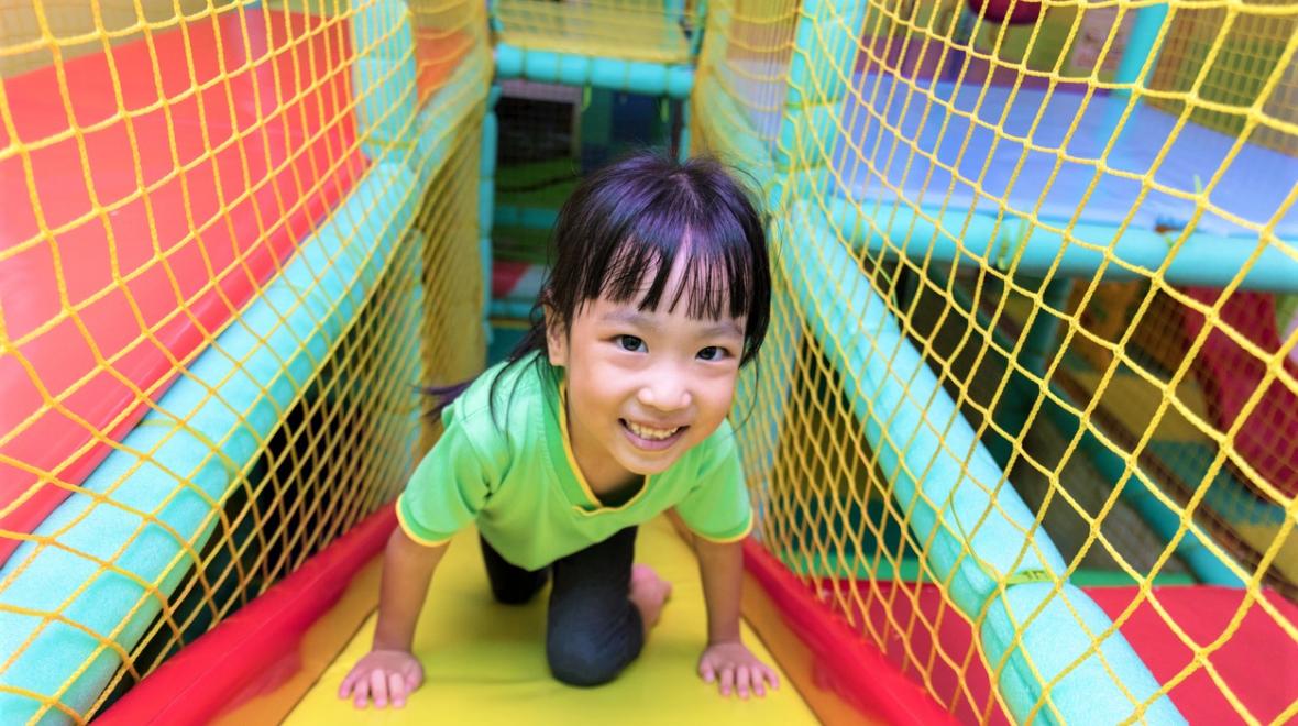 girl playing in indoor play gym