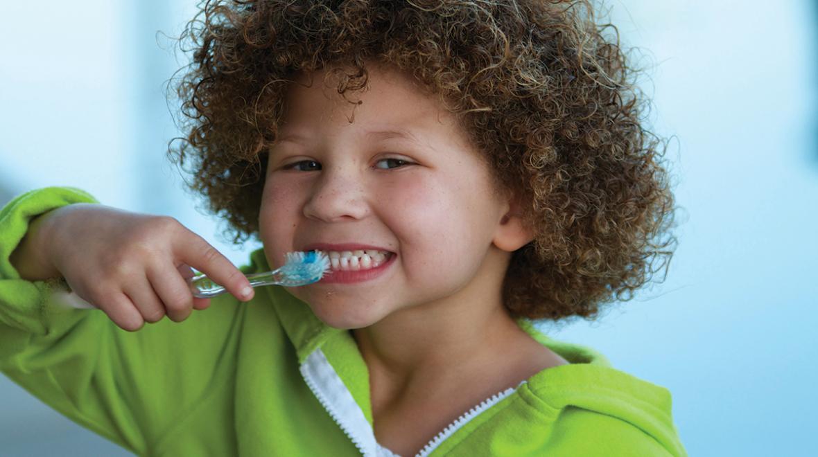 Cute kid brushing his teeth