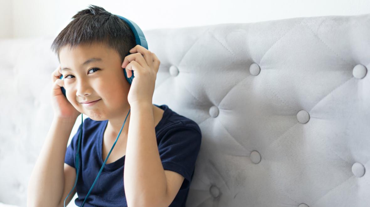 boy listening to a podcast on headphones