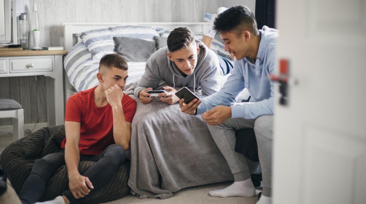 teen boys looking at their phones