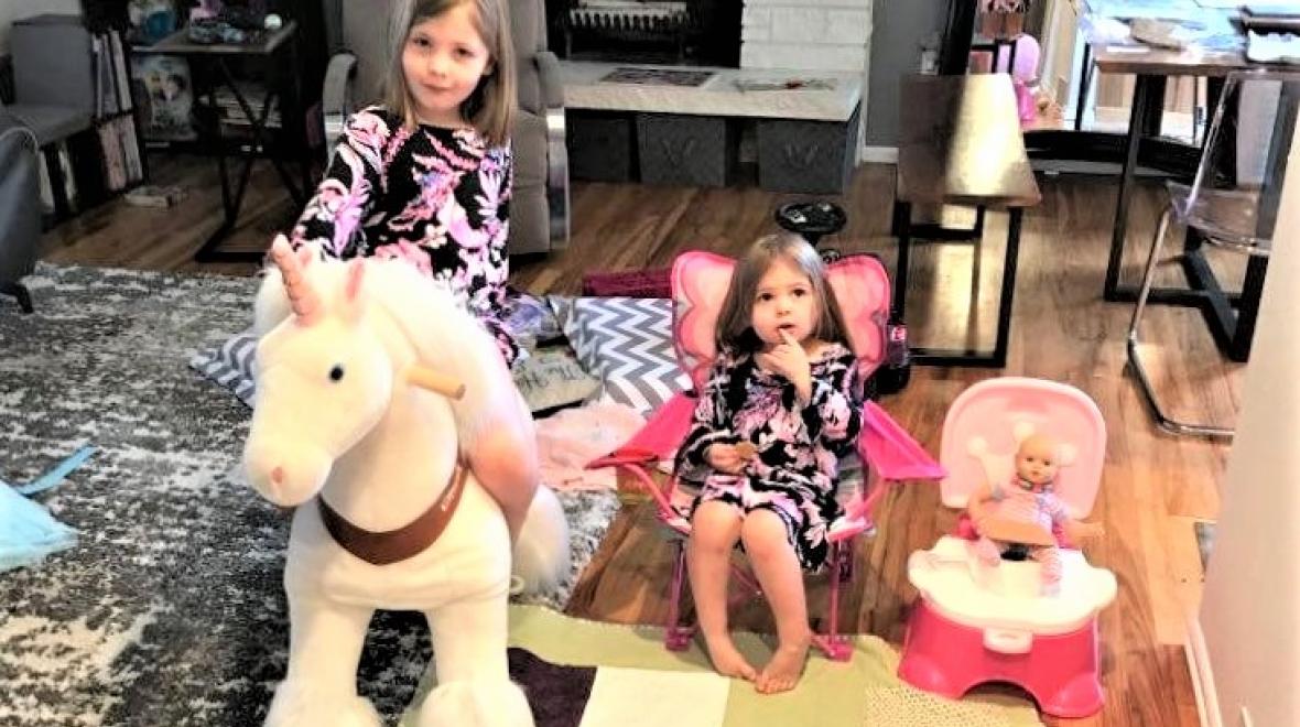 Girls-in-living-room-on-toy-horse-chair-doll-on-princess-potty
