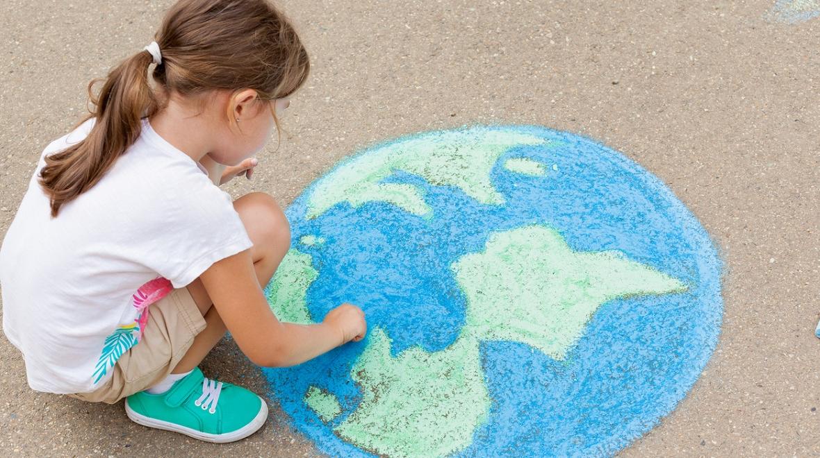 girl drawing earth on sidewalk with chalk kids become activists eco learning at home