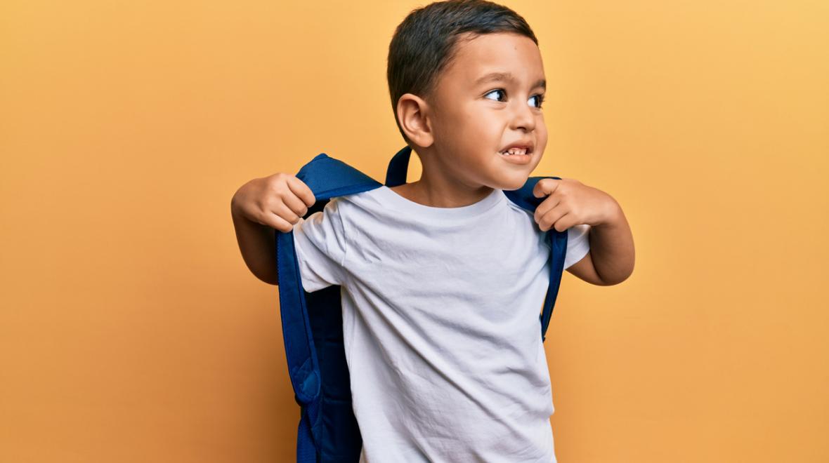 cute latino toddler wearing a backpack 
