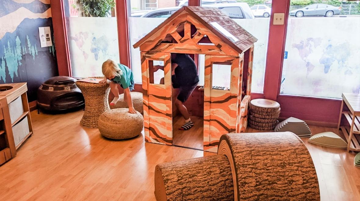 Kids playing in a playhouse inside new Seattle-area indoor play space Child Wonder the World inspiring global learning
