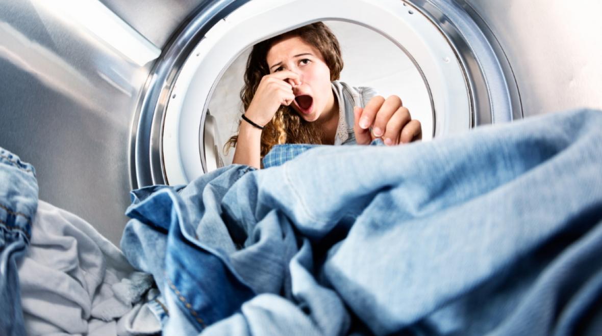 Parent-smelling-stinky-clothes-in-washing-machine