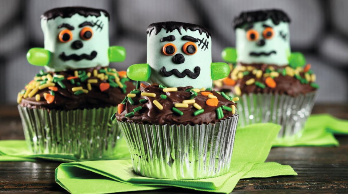 Three cupcakes decorated with friendly looking monsters