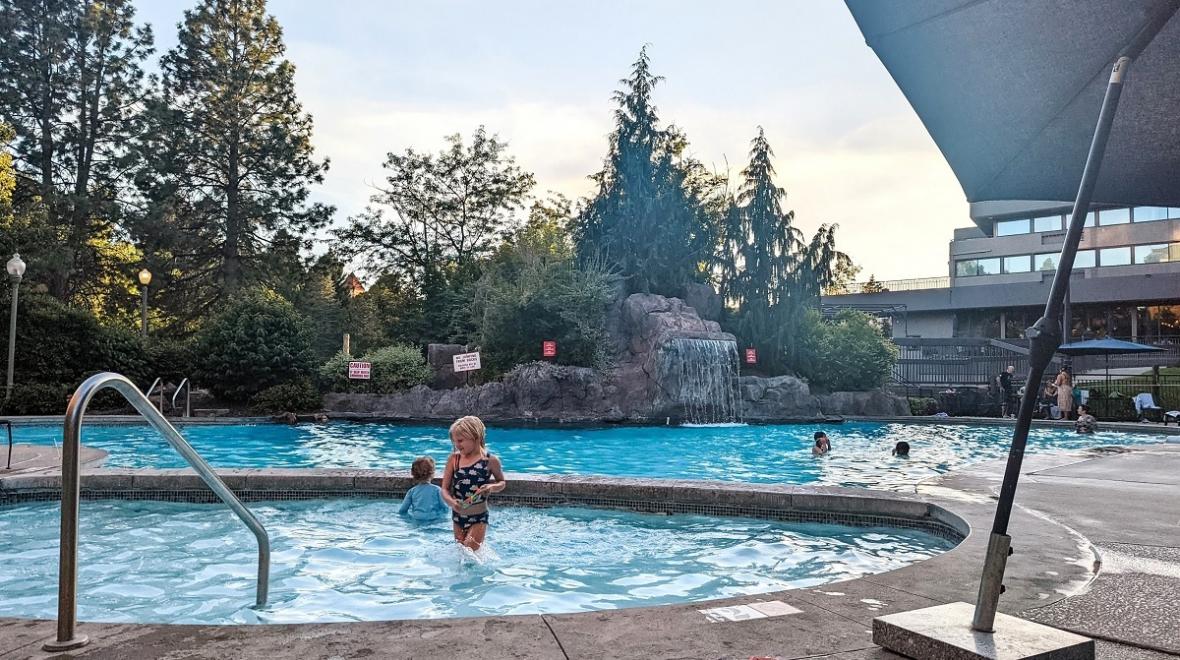A young girl stands in the smaller pool of two pools at Spokane's Centennial Hotel, centrally located base for families visiting Spokane
