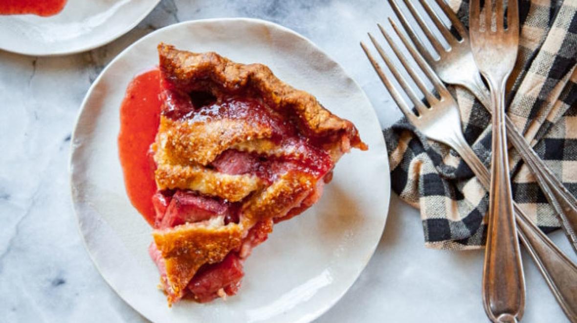 A plate with a slice of strawberry rhubarb pie