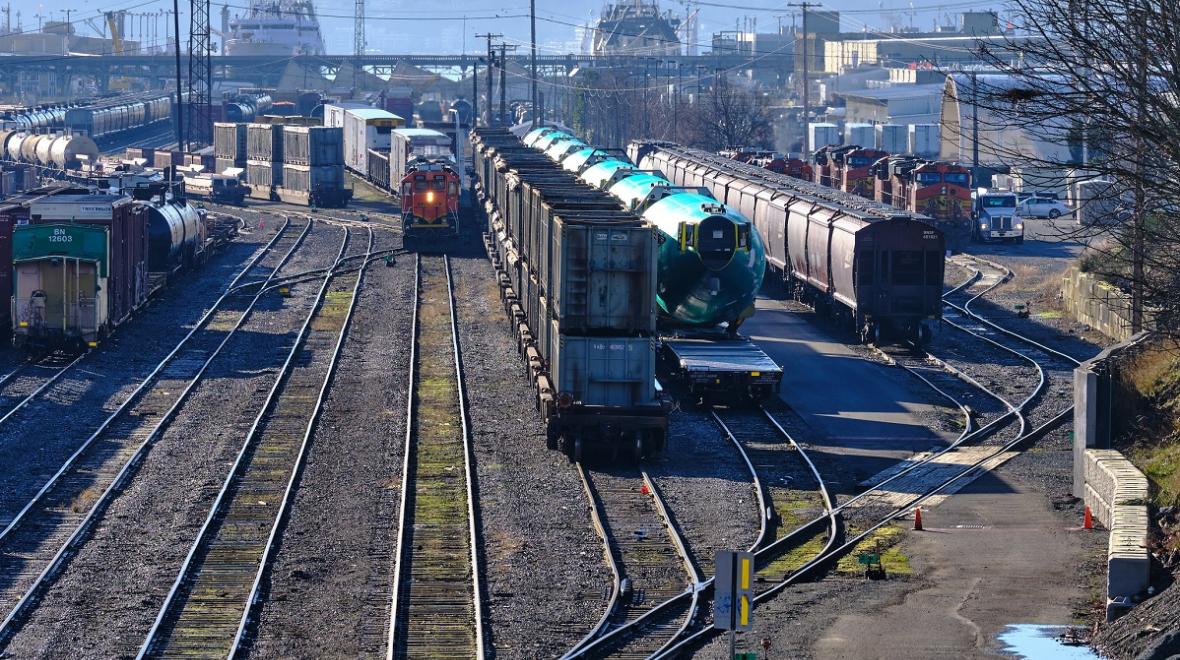 Looking over the tracks at Seattle's Balmer Yard with a view of BNSF trains including Boeing fuselage parts on train cars