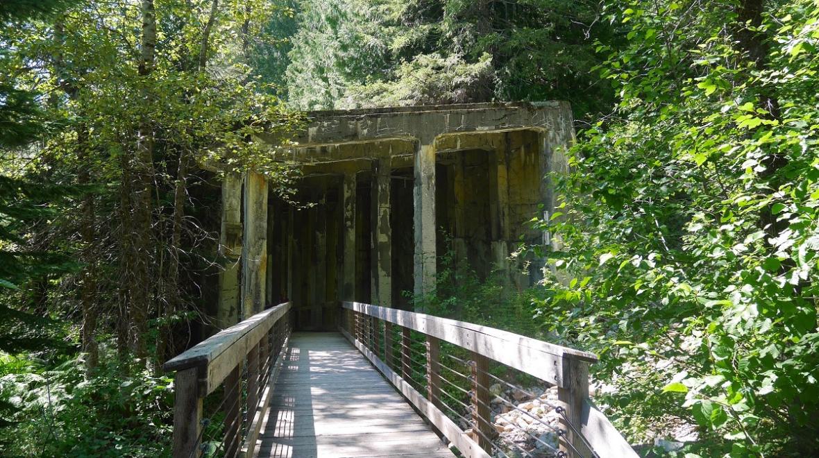 Ghost town hikes near Seattle include the Iron Goat Trail where the entrance to an abandoned mine shaft can be seen along the trail