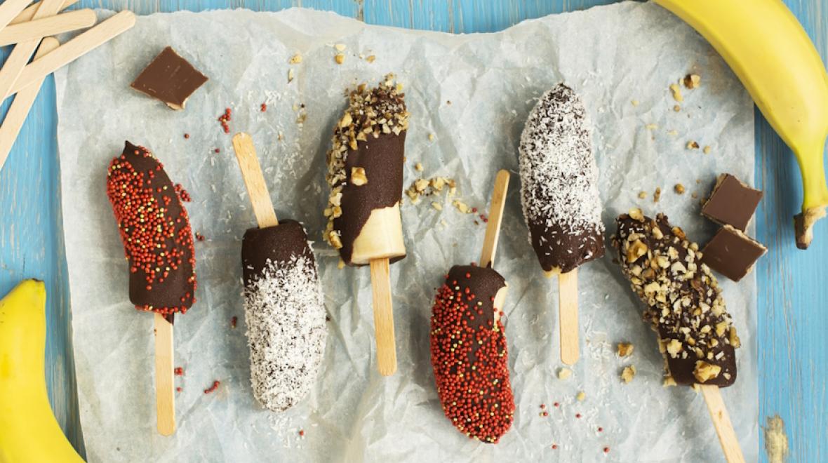 Frozen bananas covered in chocolate and sprinkles 