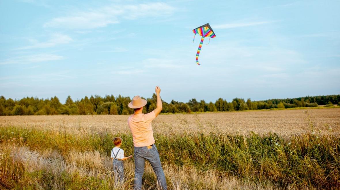 Dad and son flying a kite in a great place to fly a kite near Seattle
