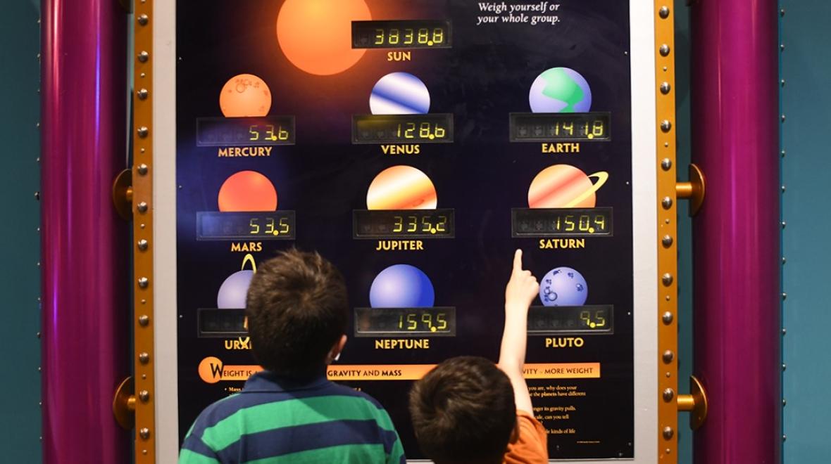 Boys interact with a science exhibit at Seattle's Pacific Science Center